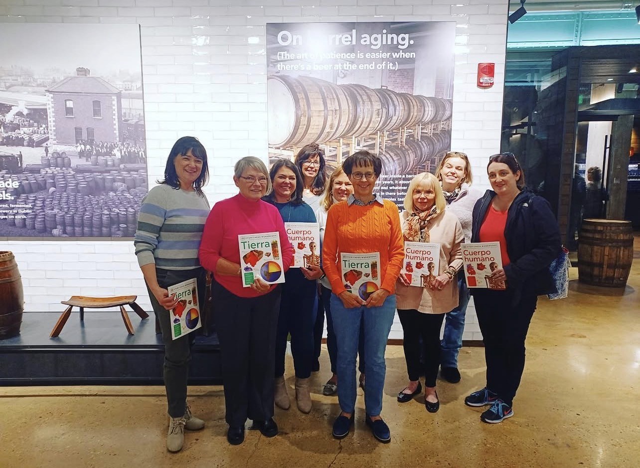 Several people holding books indoors