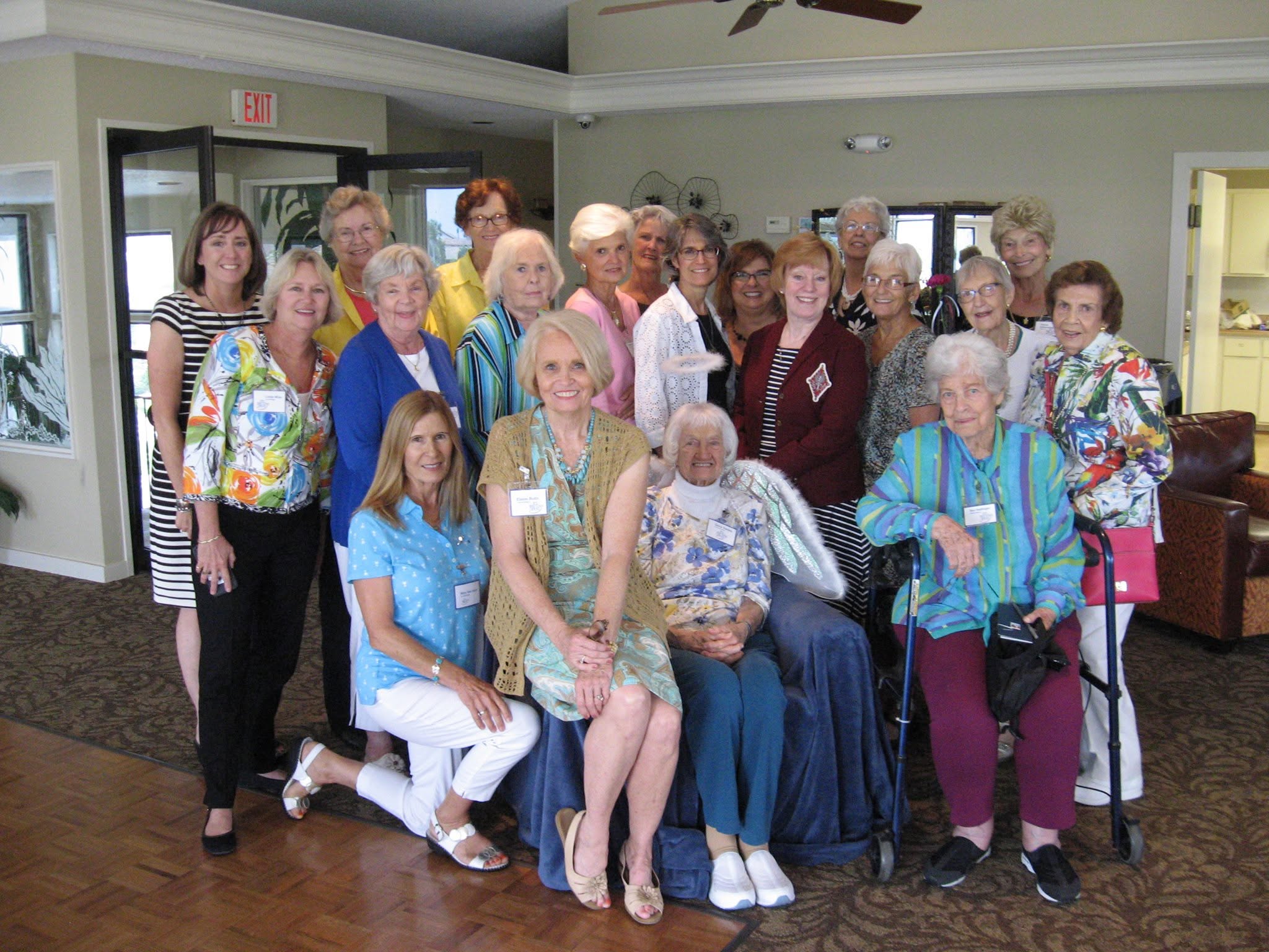 Multiple people posed indoors, smiling