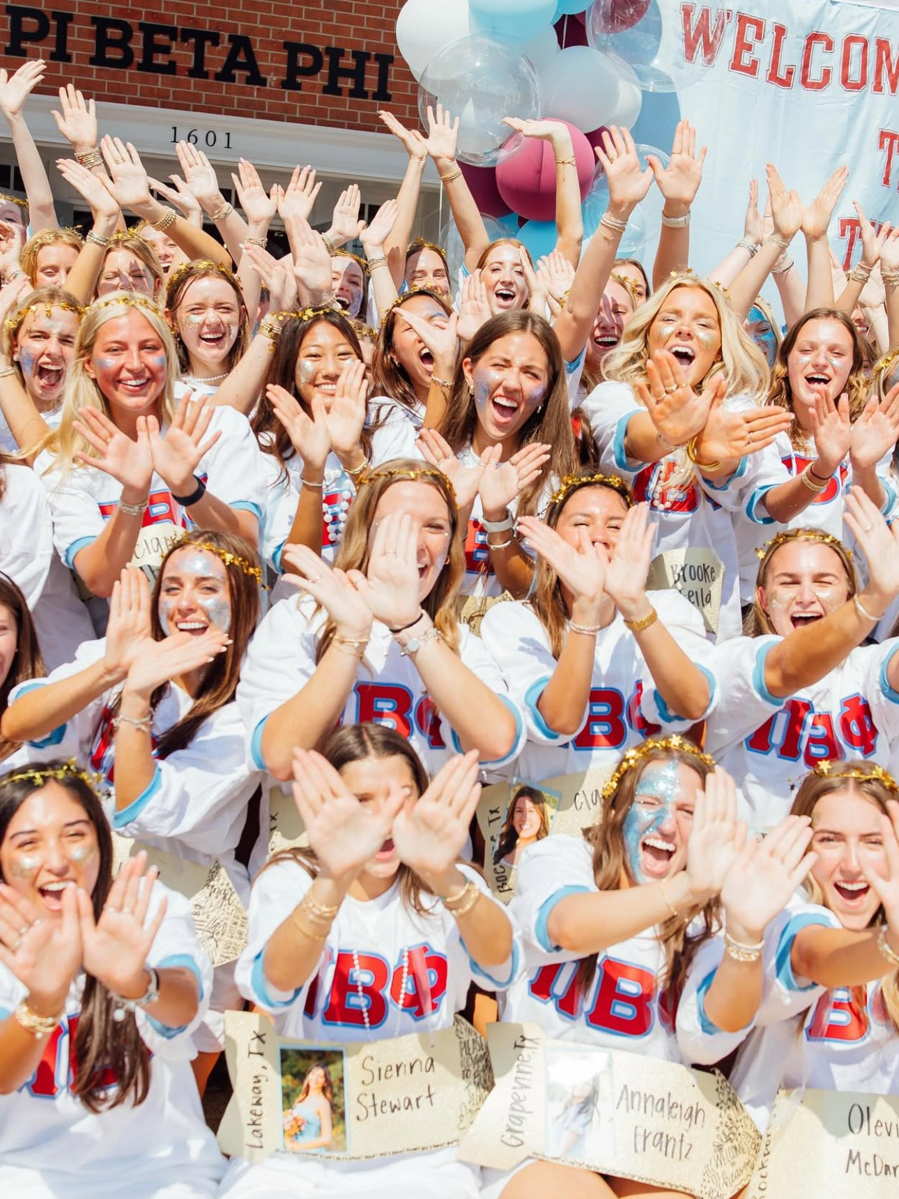 Group of members standing outdoors making their hands into angel wings