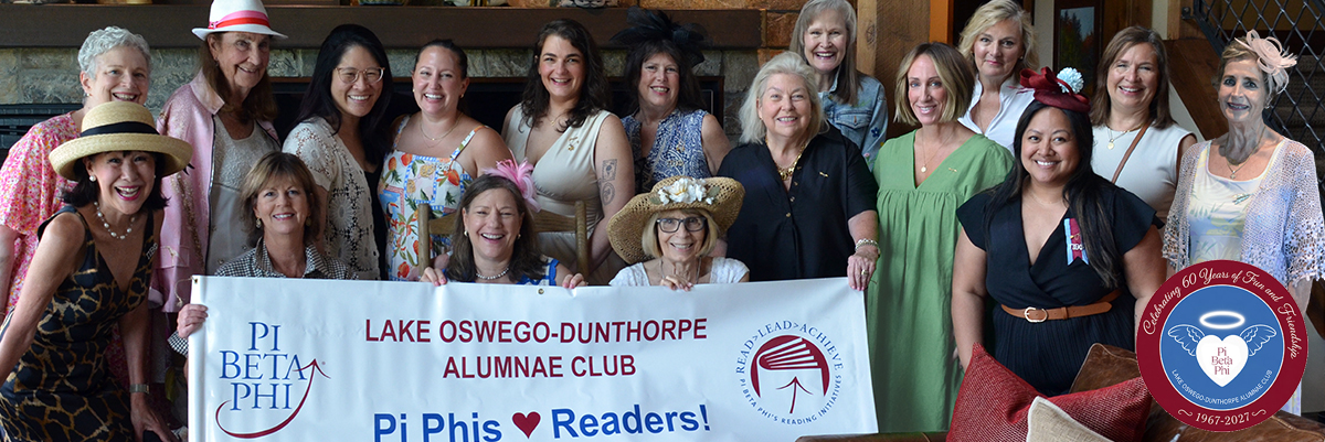 Several members standing behind a banner that says Lake Oswego-Dunthorpe Alumnae Club Pi Phis Love Readers!