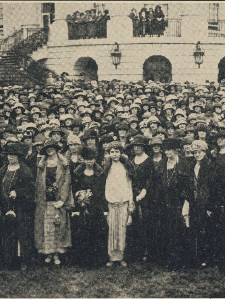 Sepia-toned historical photograph of a large crowd of Pi Beta Phi members gathered on steps and lawn outside a grand building during a convention in 1920s era clothing and hats