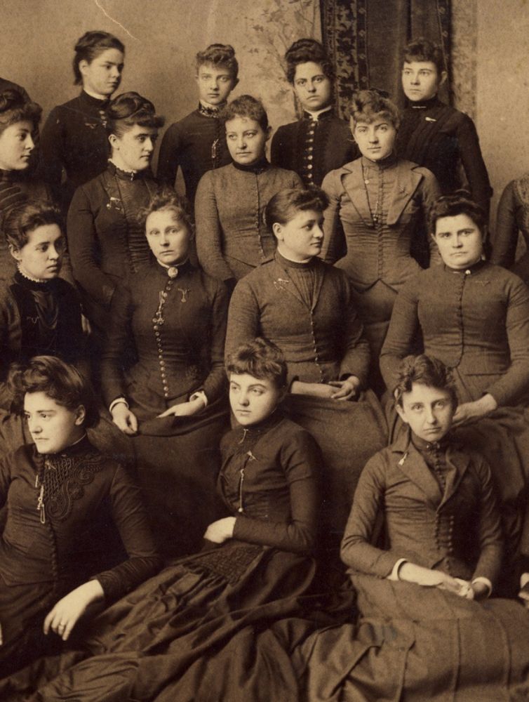 Sepia-toned historical group portrait of Pi Beta Phi members in Victorian-era dress