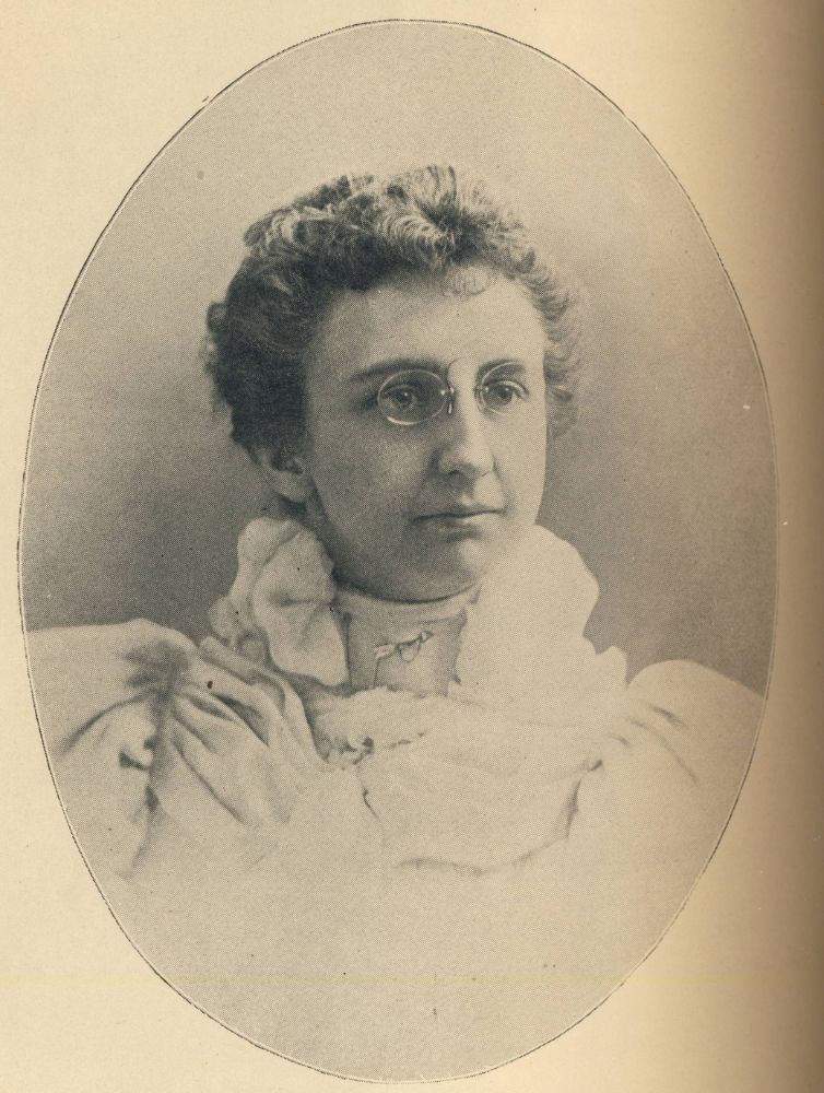 Black and white oval portrait photograph of a Pi Beta Phi member wearing glasses and a ruffled Victorian-era blouse