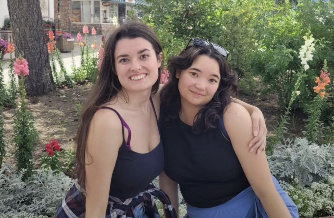 Two individuals sitting outdoors