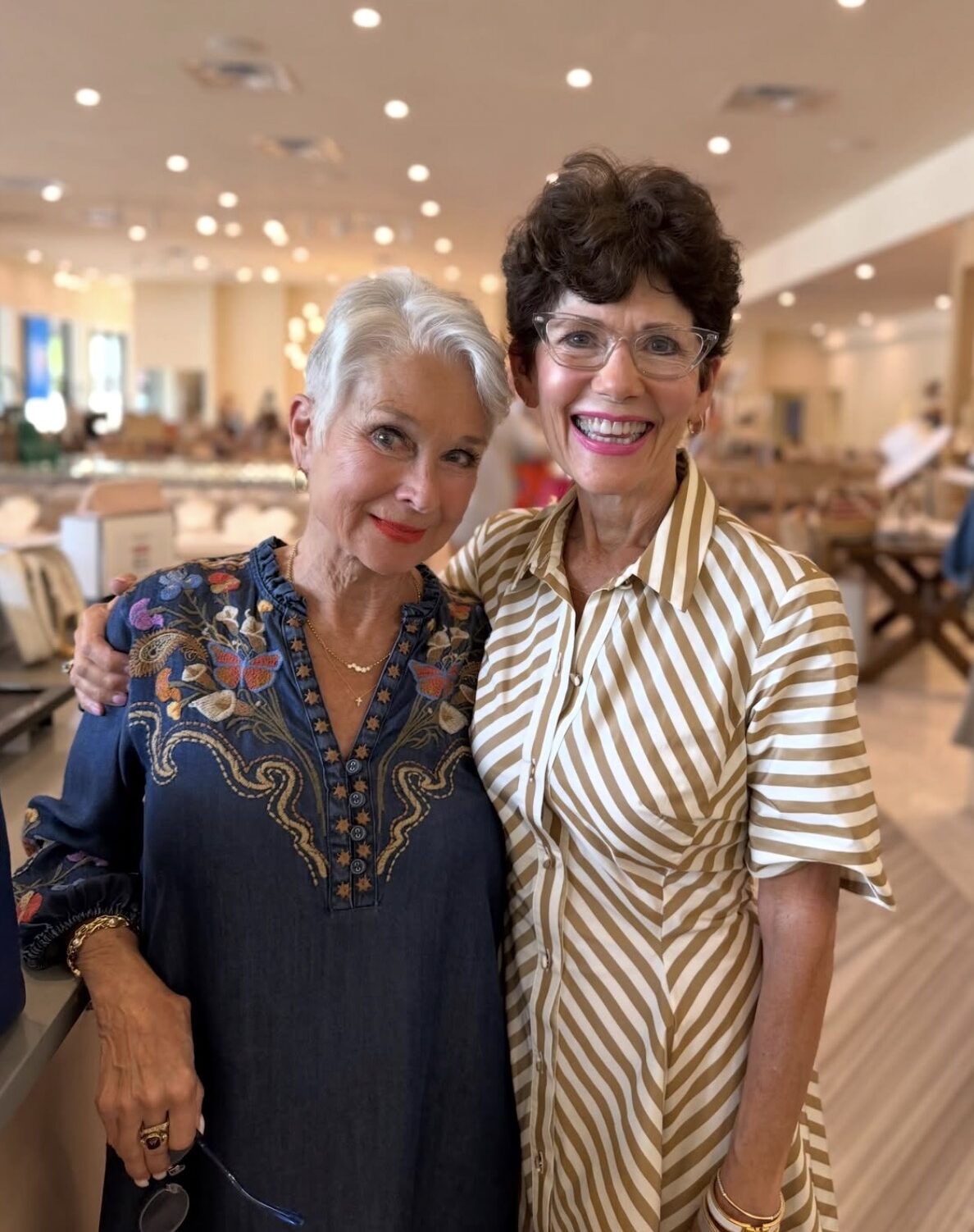 Two individuals standing indoors