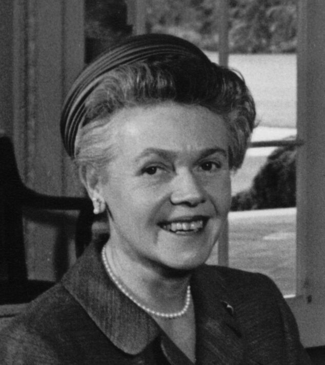 Historical black and white headshot of Eugenie Anderson wearing a collared shirt and pearls in front of a window