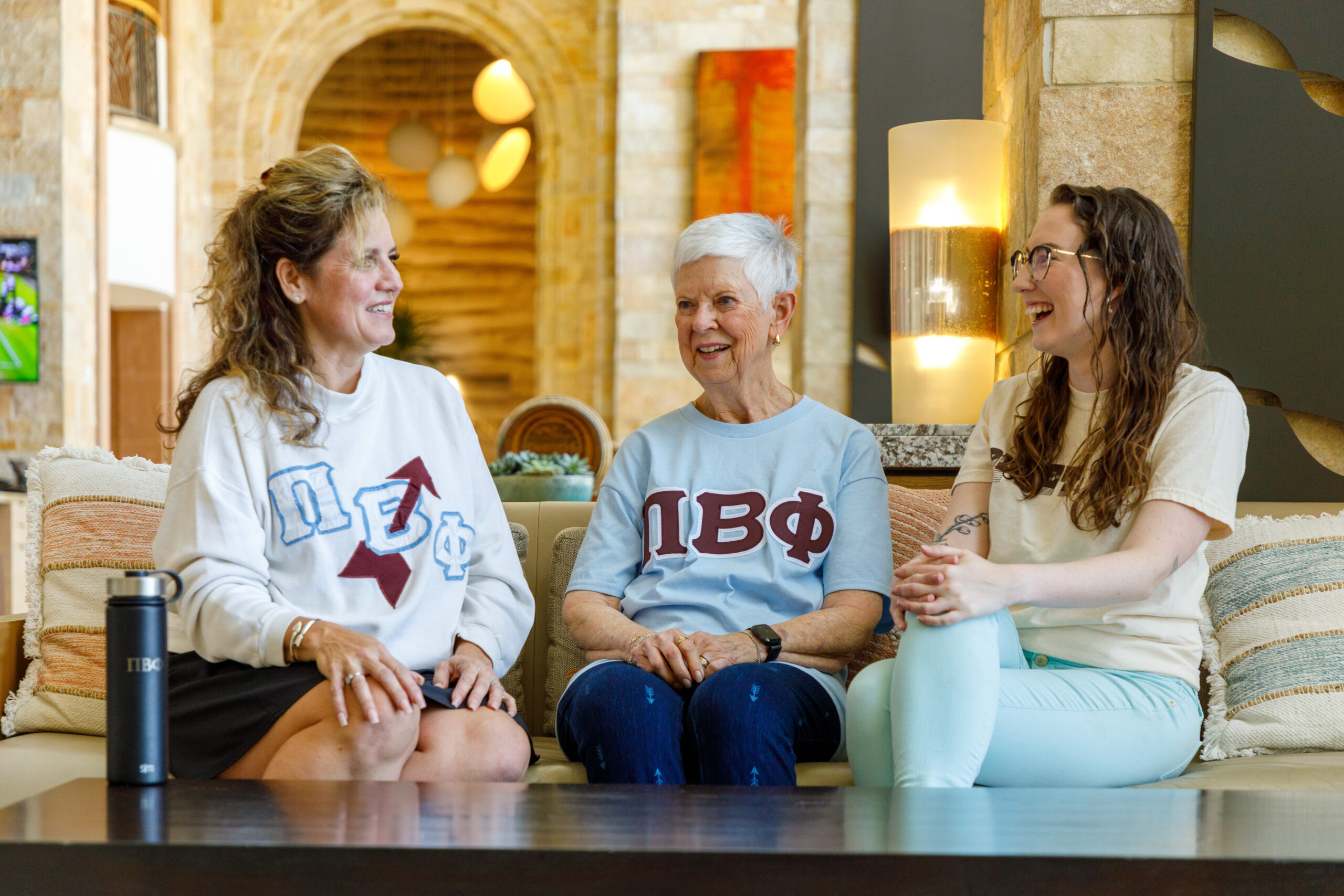 Three members sitting on a couch