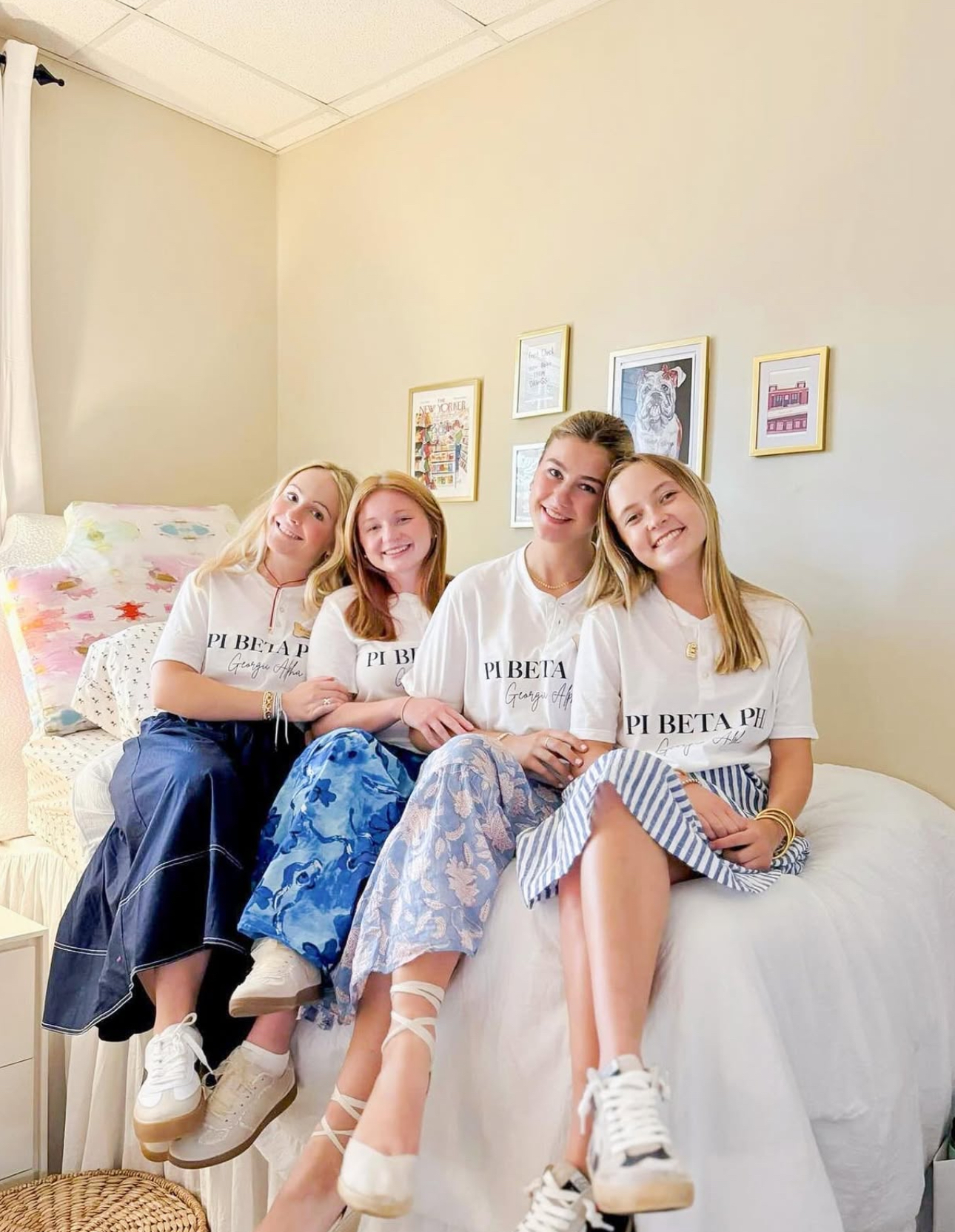 Four individuals sitting on a bed