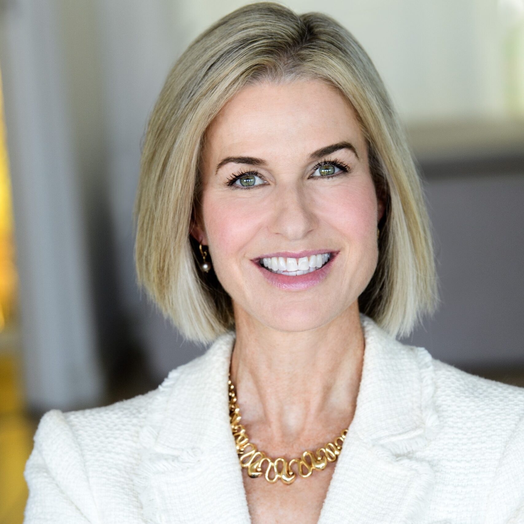 Professional headshot of Janet McKillop wearing a white blazer
