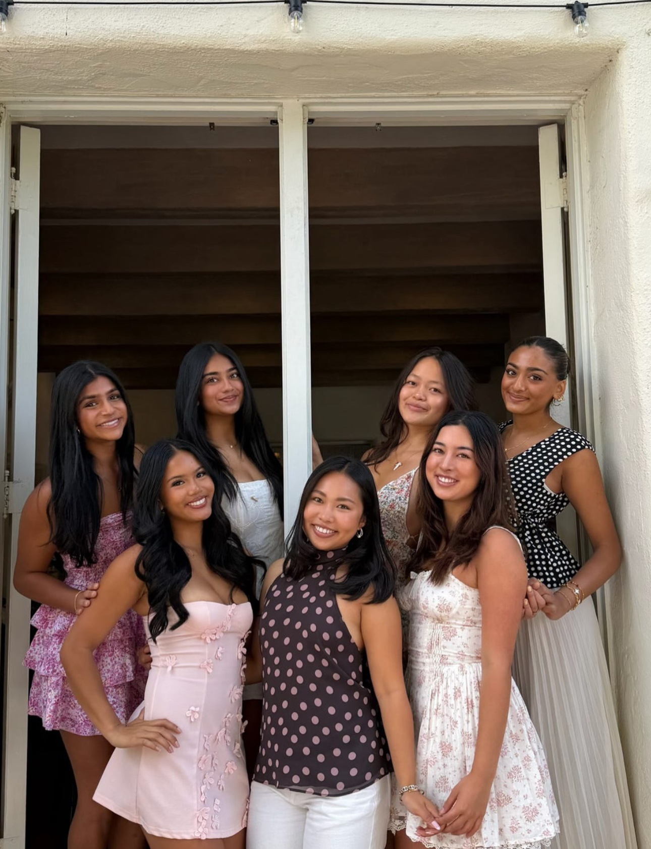 Seven members standing in a doorway
