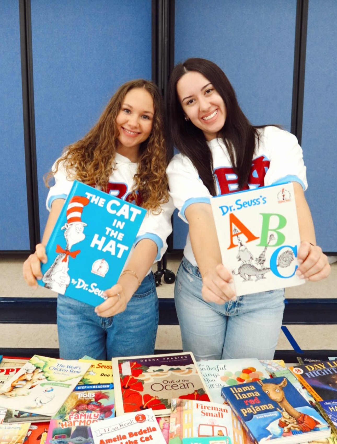 Two members holding children's books