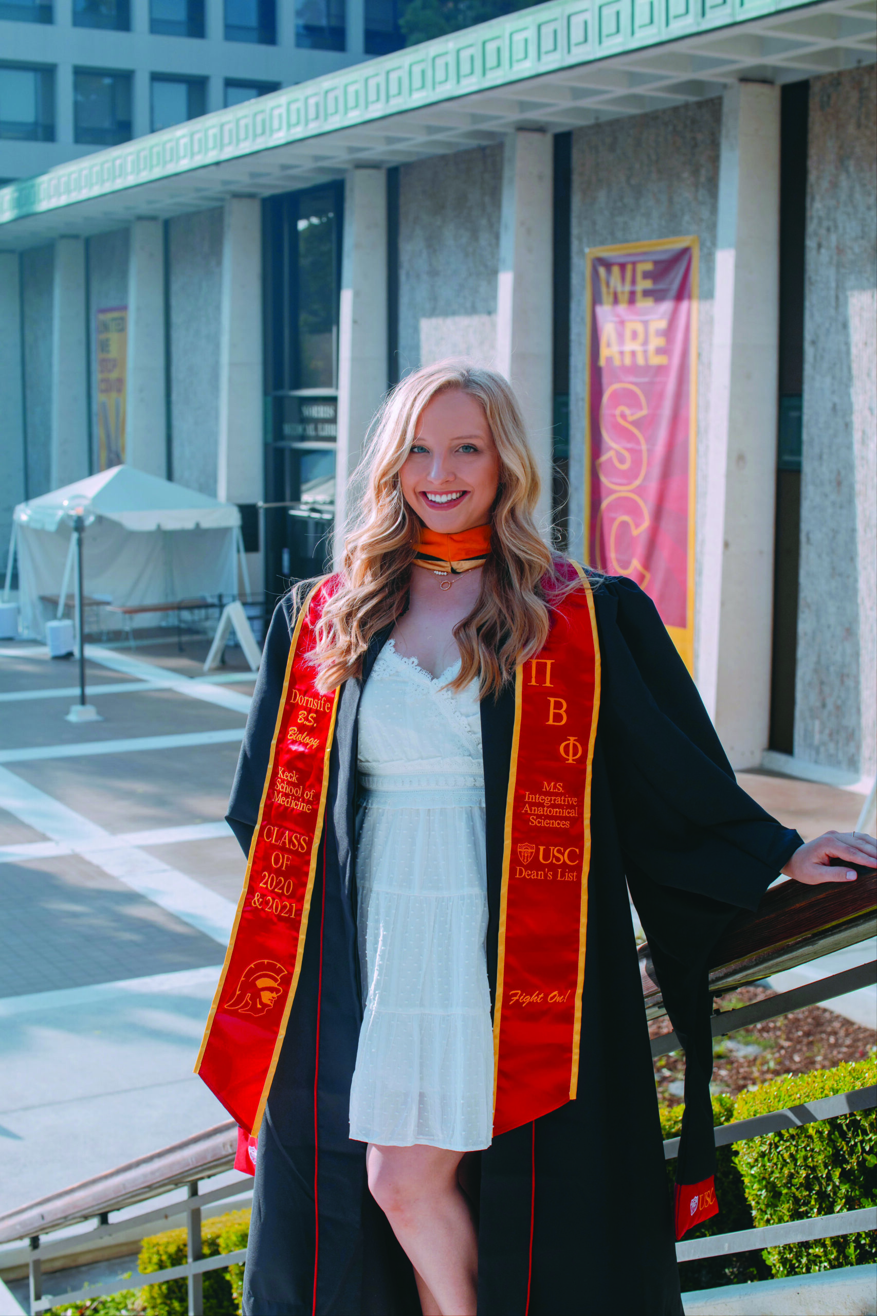 One member wearing a graduate robe and stole