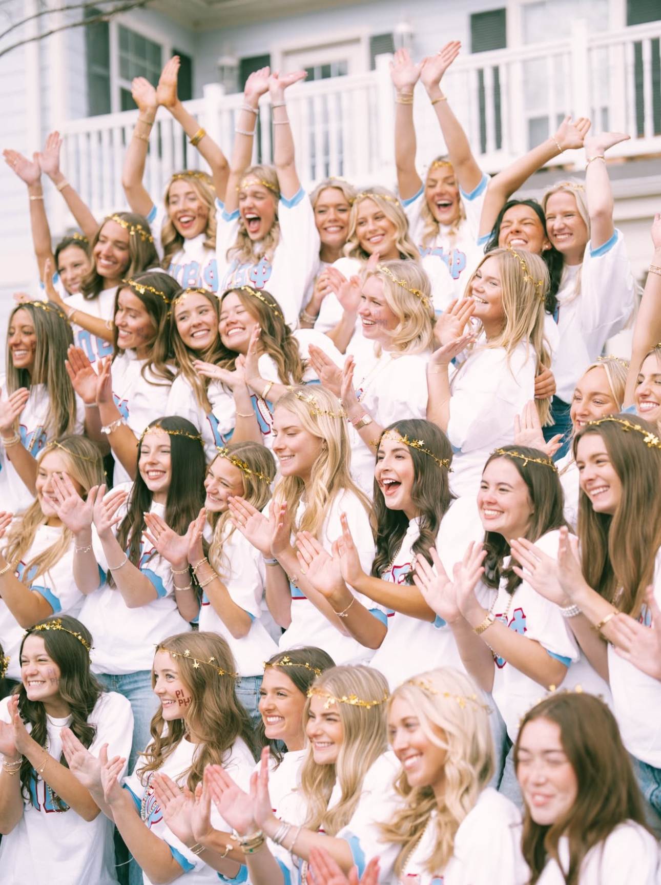 Several members standing outside holding up their hands to make angel wings