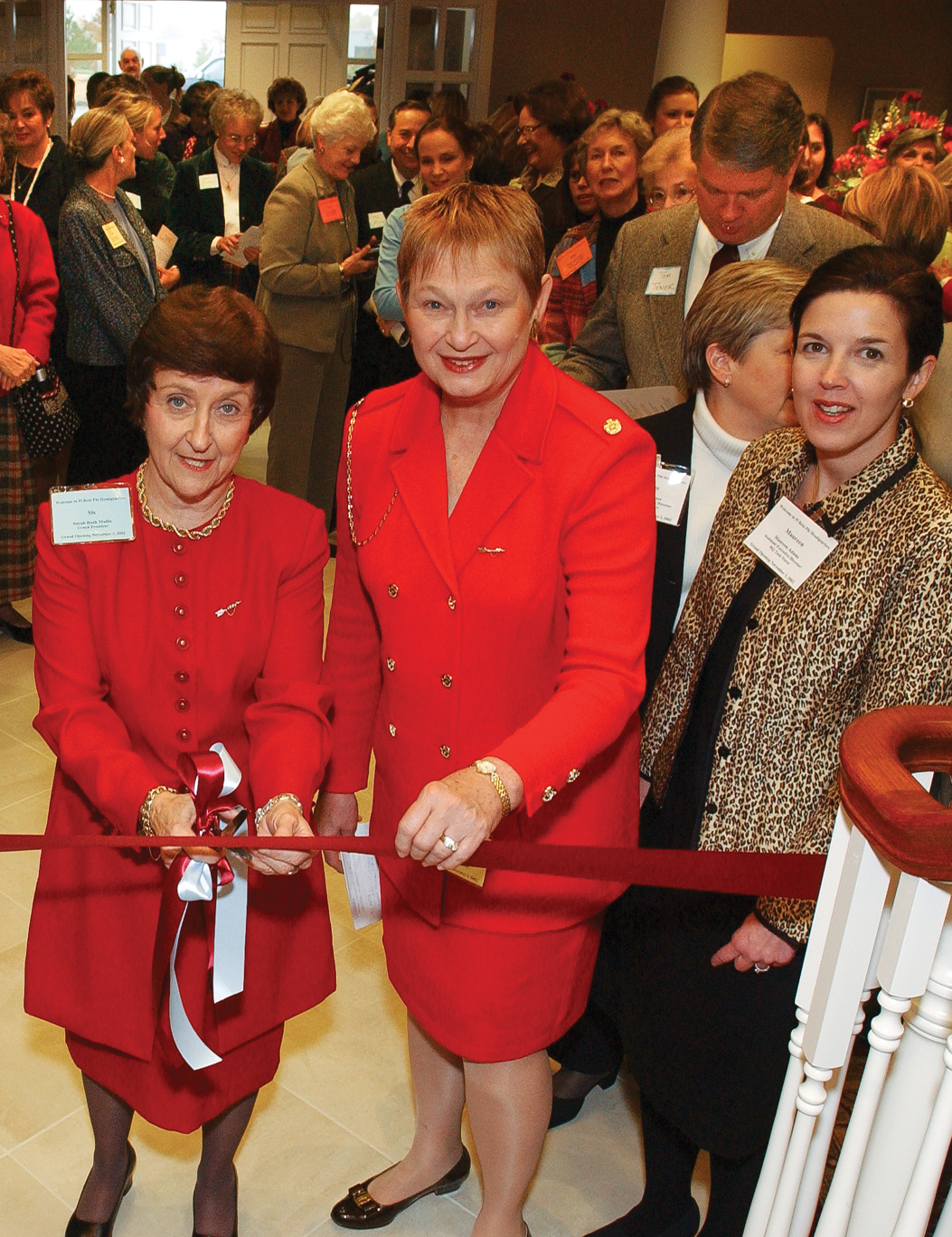 Two members cutting a ribbon across a stairway