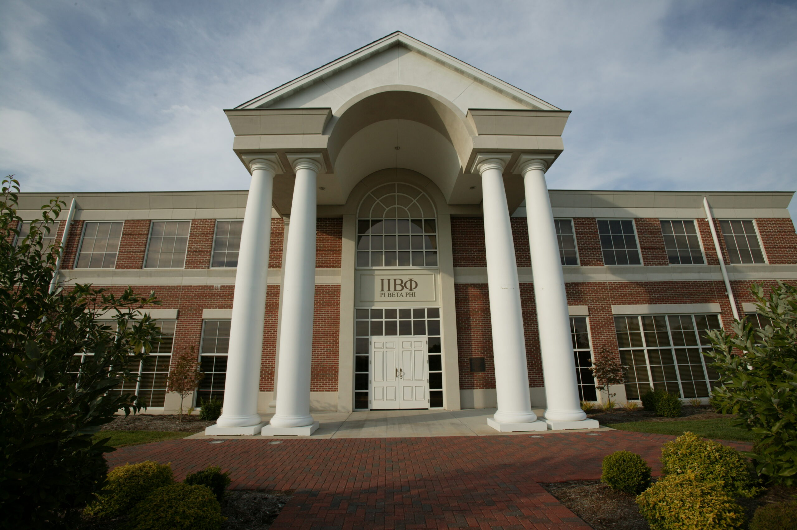Large brick building with white columns and Pi Beta Phi Greek letters