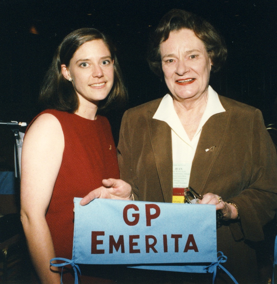 Two members standing together holding banner that says GP Emerita