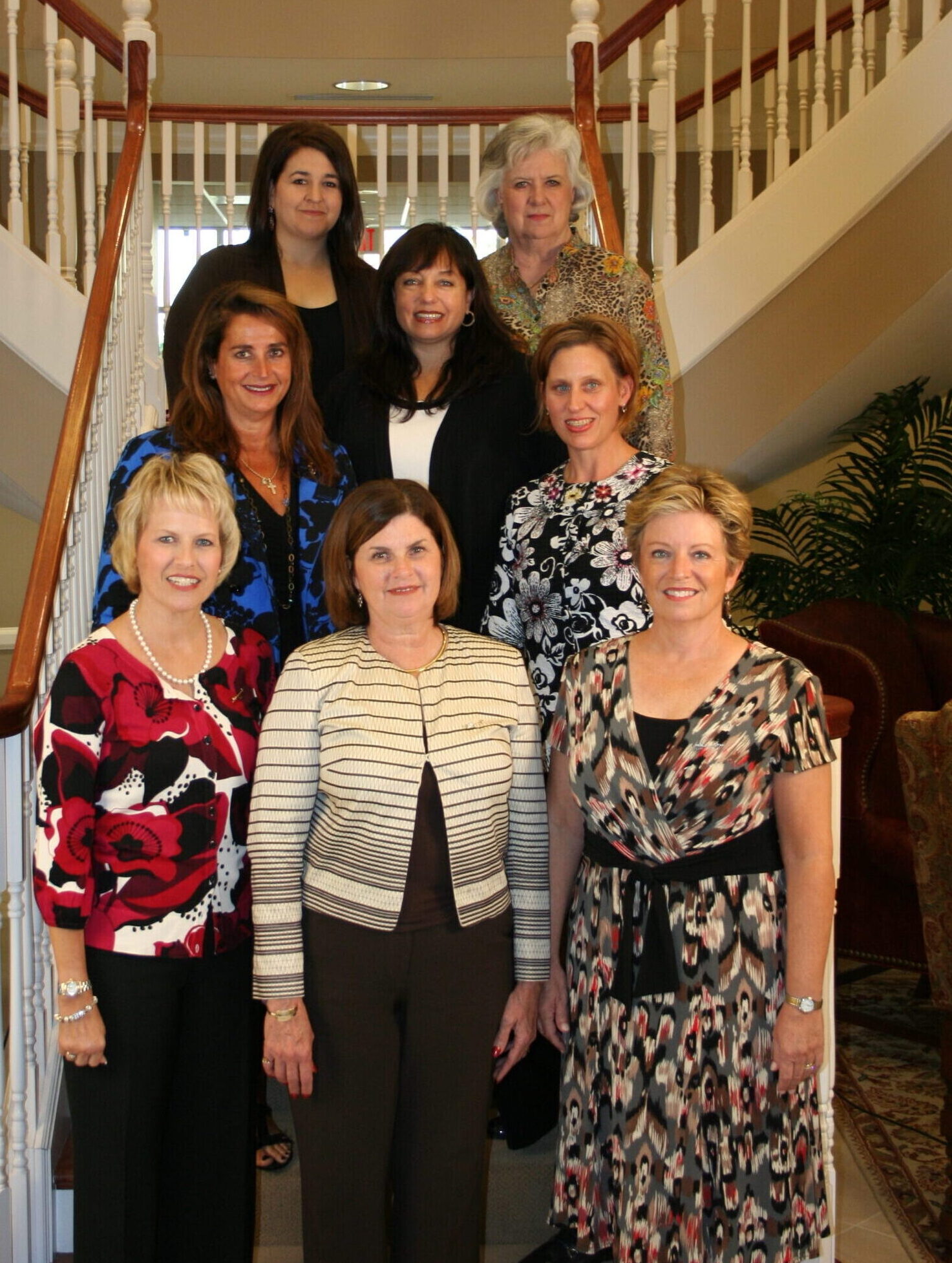 Eight members standing on a staircase