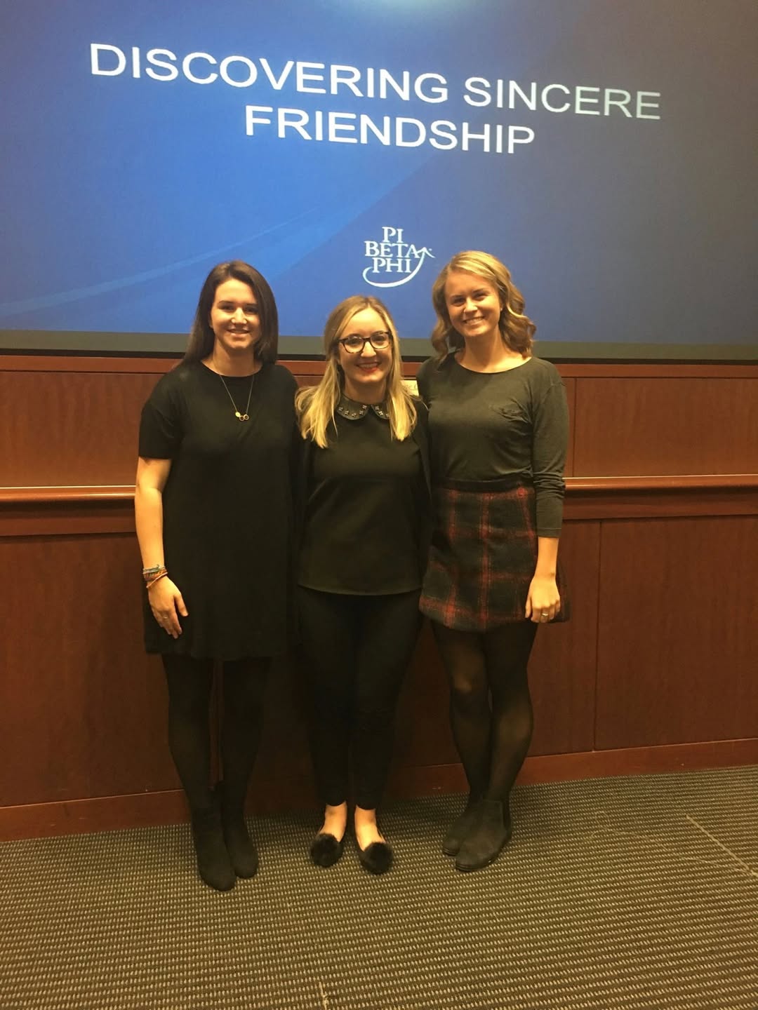 Three members standing in front of a screen that says Discovering Sincere Friendship