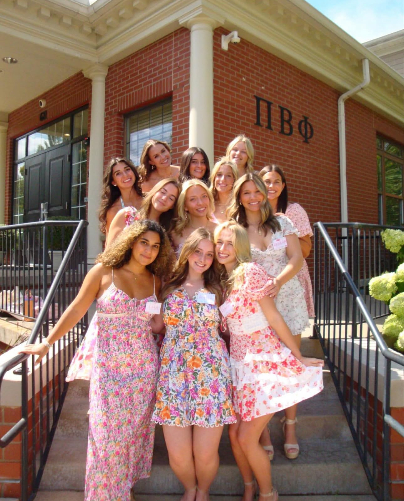 A group of individuals standing in front of a chapter house