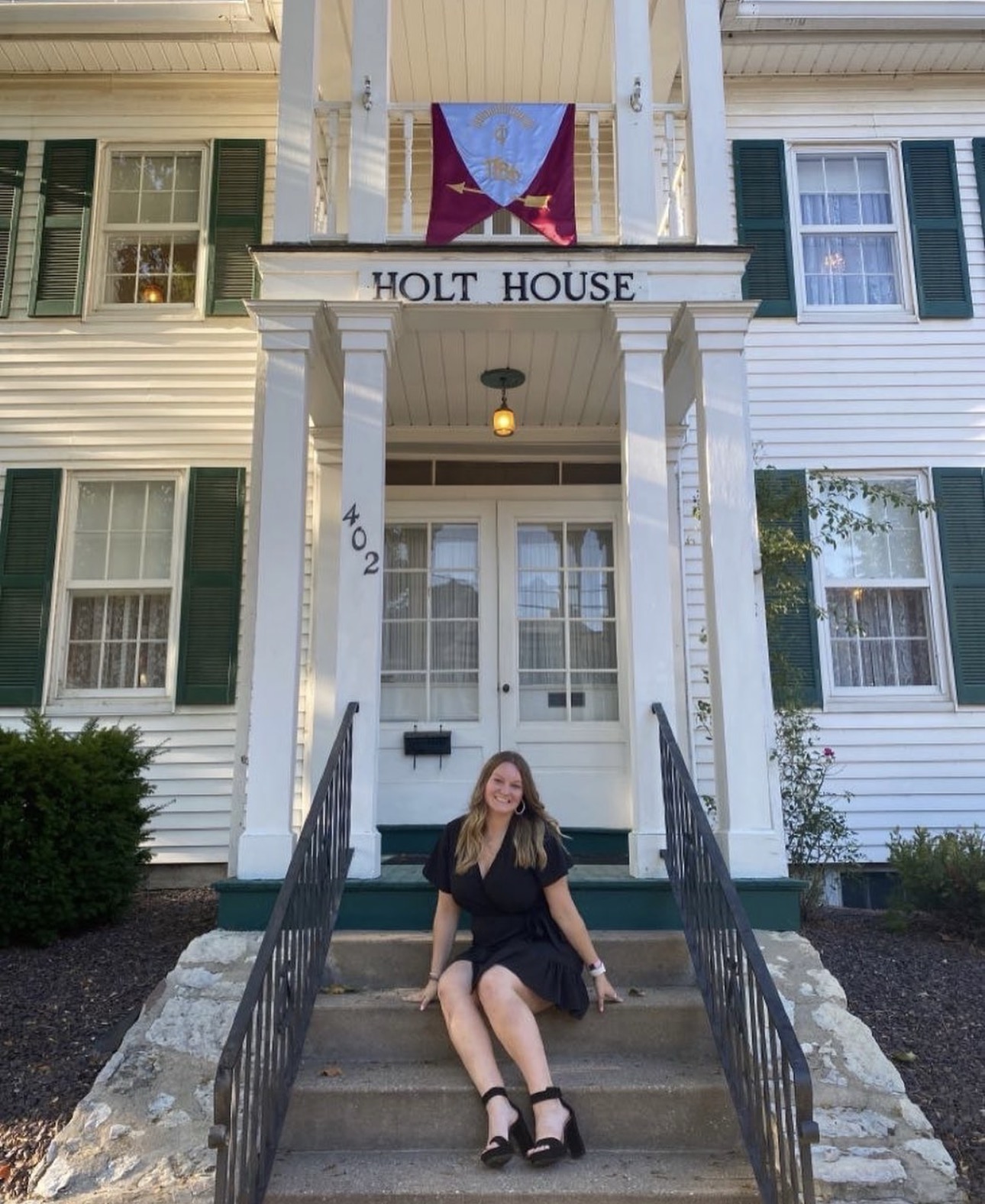 One member sitting on the steps of Holt House