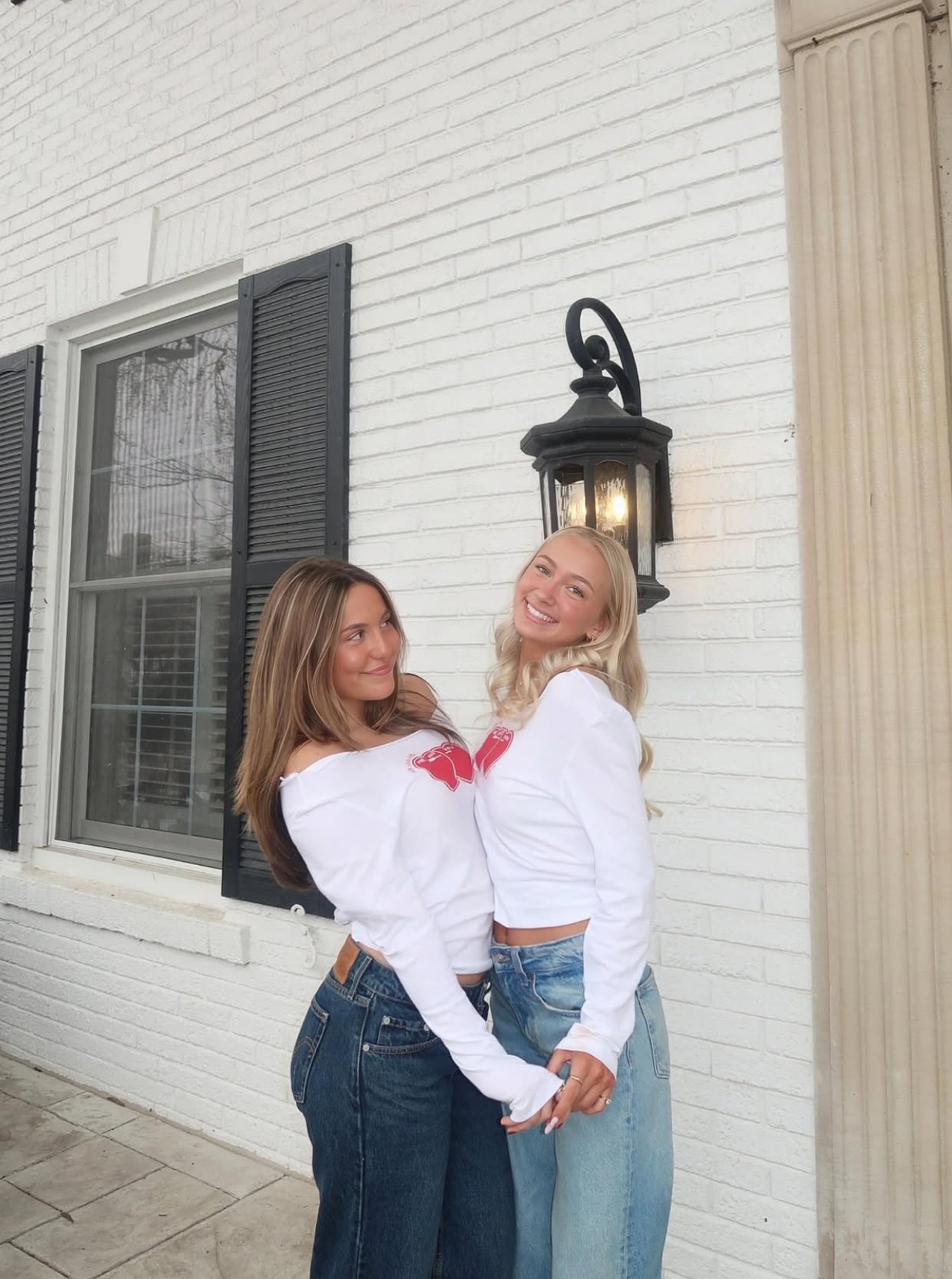 Two individuals standing in front of a building
