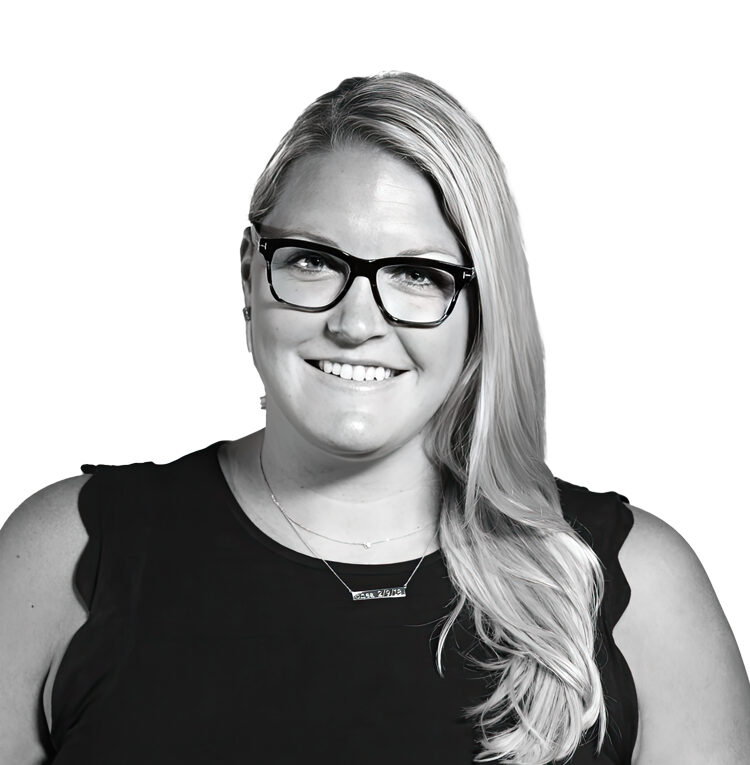Black and white professional headshot of Jayne Appel wearing a black top and black glasses in front of a white background