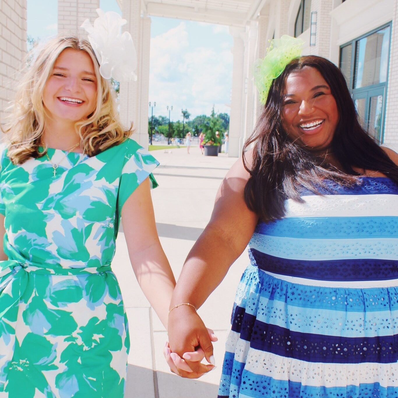 Two members holding hands and walking toward the camera