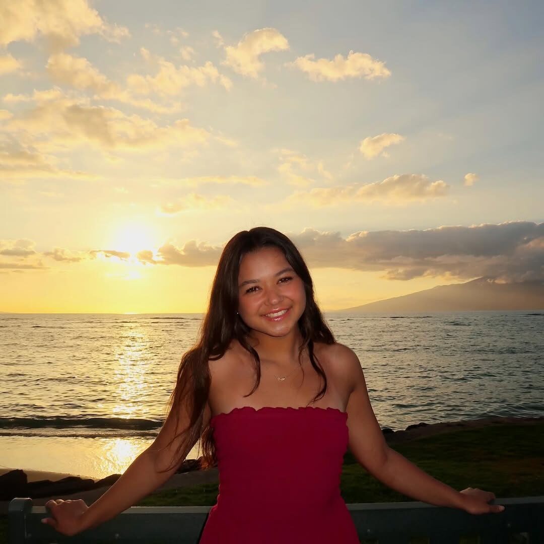 Photo of Dana Smith standing in front of a sunset