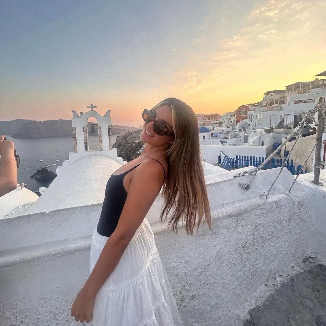 Photo of Taylor Viducic standing in front of a city skyline