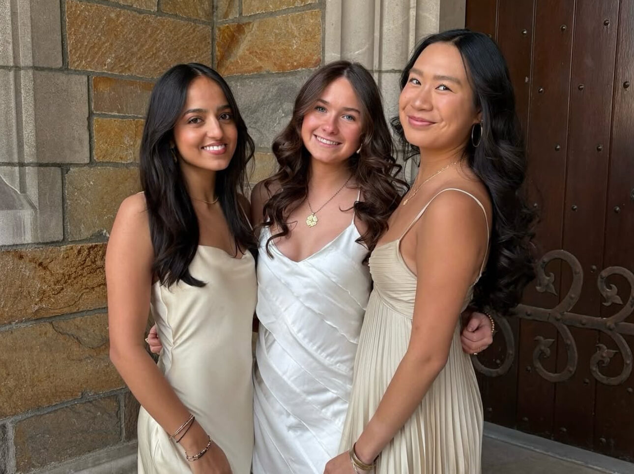 Three members standing outside