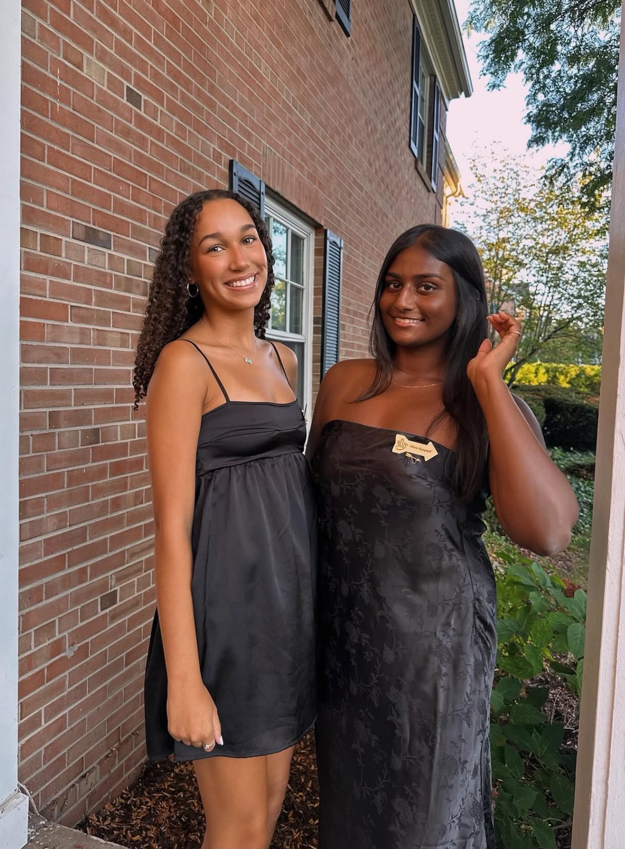 Two members standing in front of the chapter house