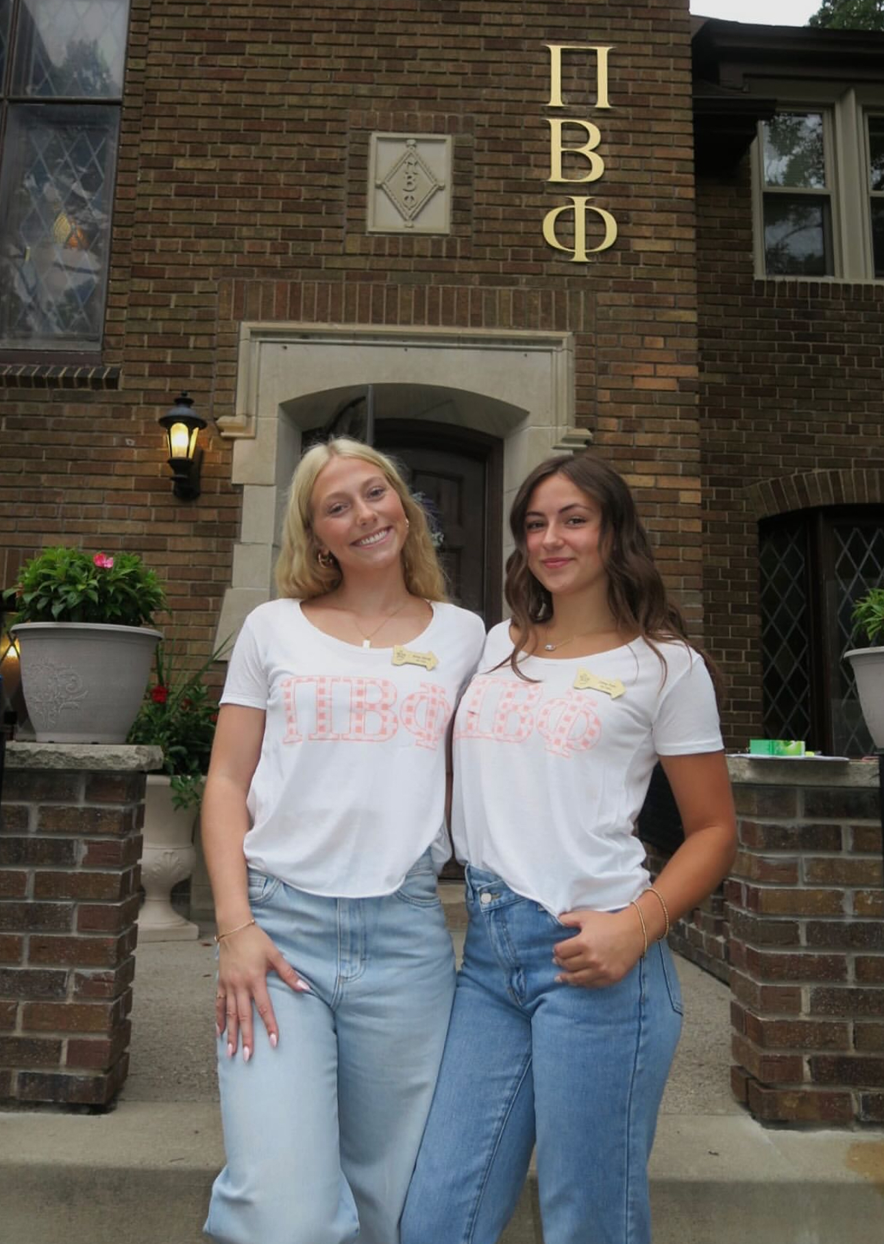 Two members standing in front of the chapter house