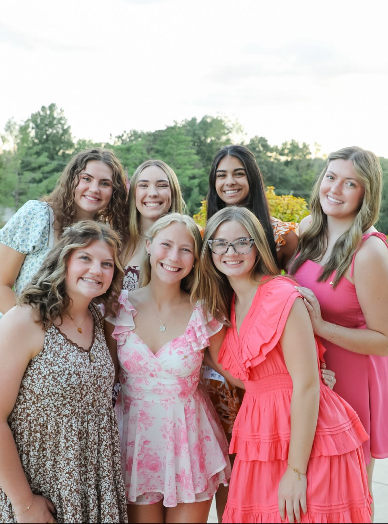 Seven members standing outdoors