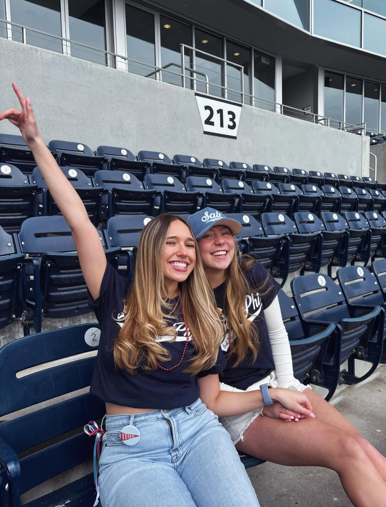 Two members sitting in a ballpark