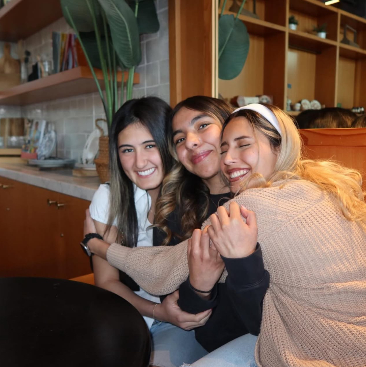 Three members hugging
