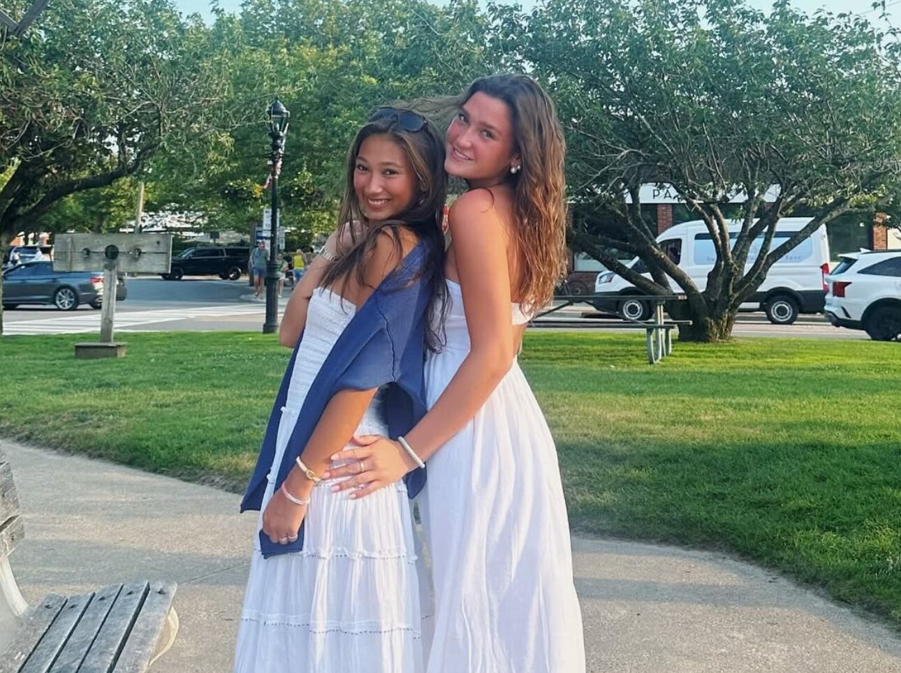 Two members standing on a sidewalk