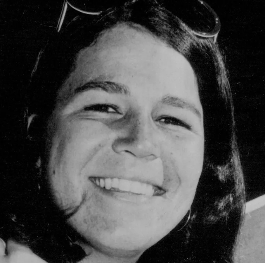 Black and white close up photo of Peggy Michel with sunglasses on top of her head