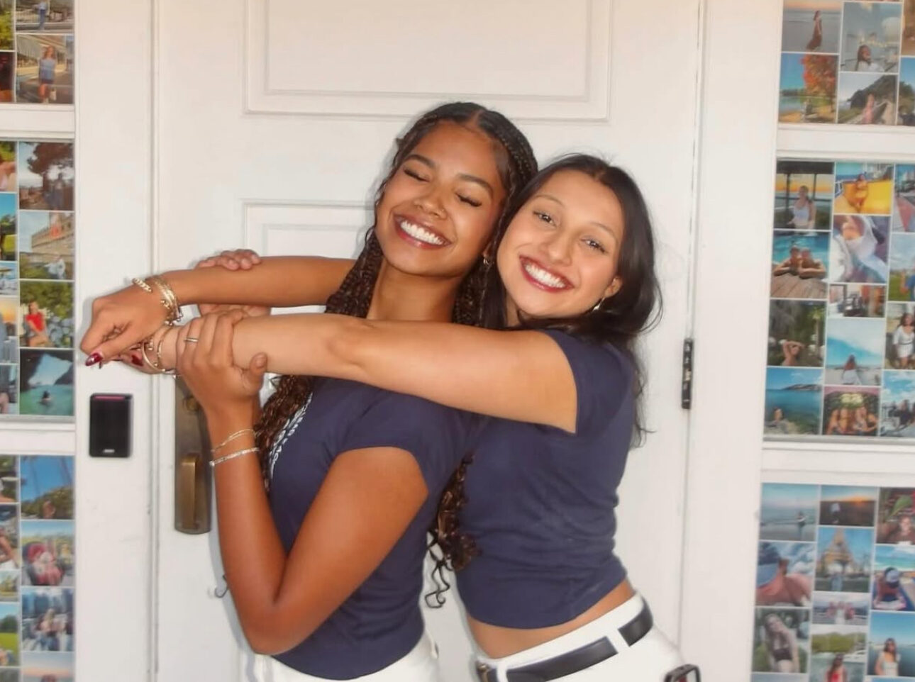 Two members hugging in front of a door