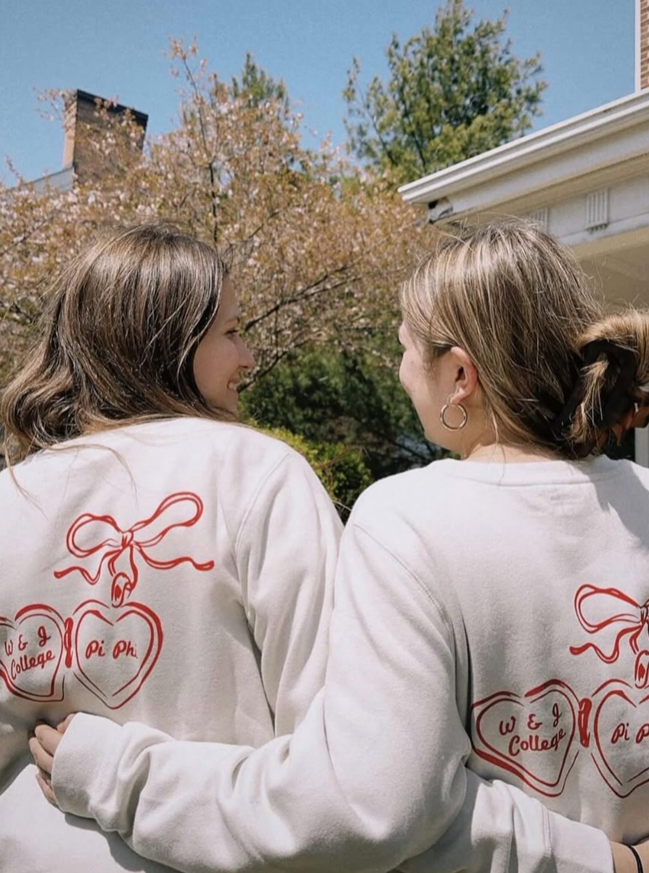 Two members with their backs to the camera looking at one another