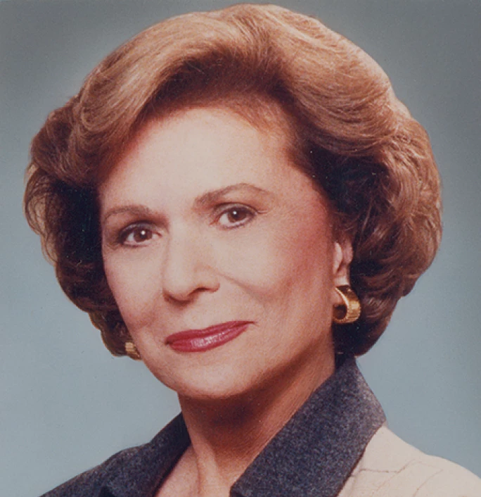 Professional headshot of Ruth Collins Sharp Altshuler wearing a black and white blazer in front of a grey background