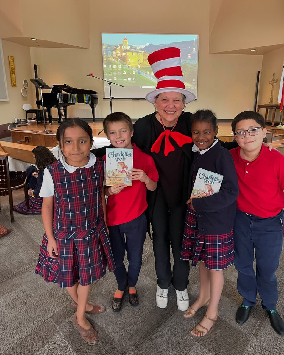 Four children with one adult wearing a cat in the hat striped hat