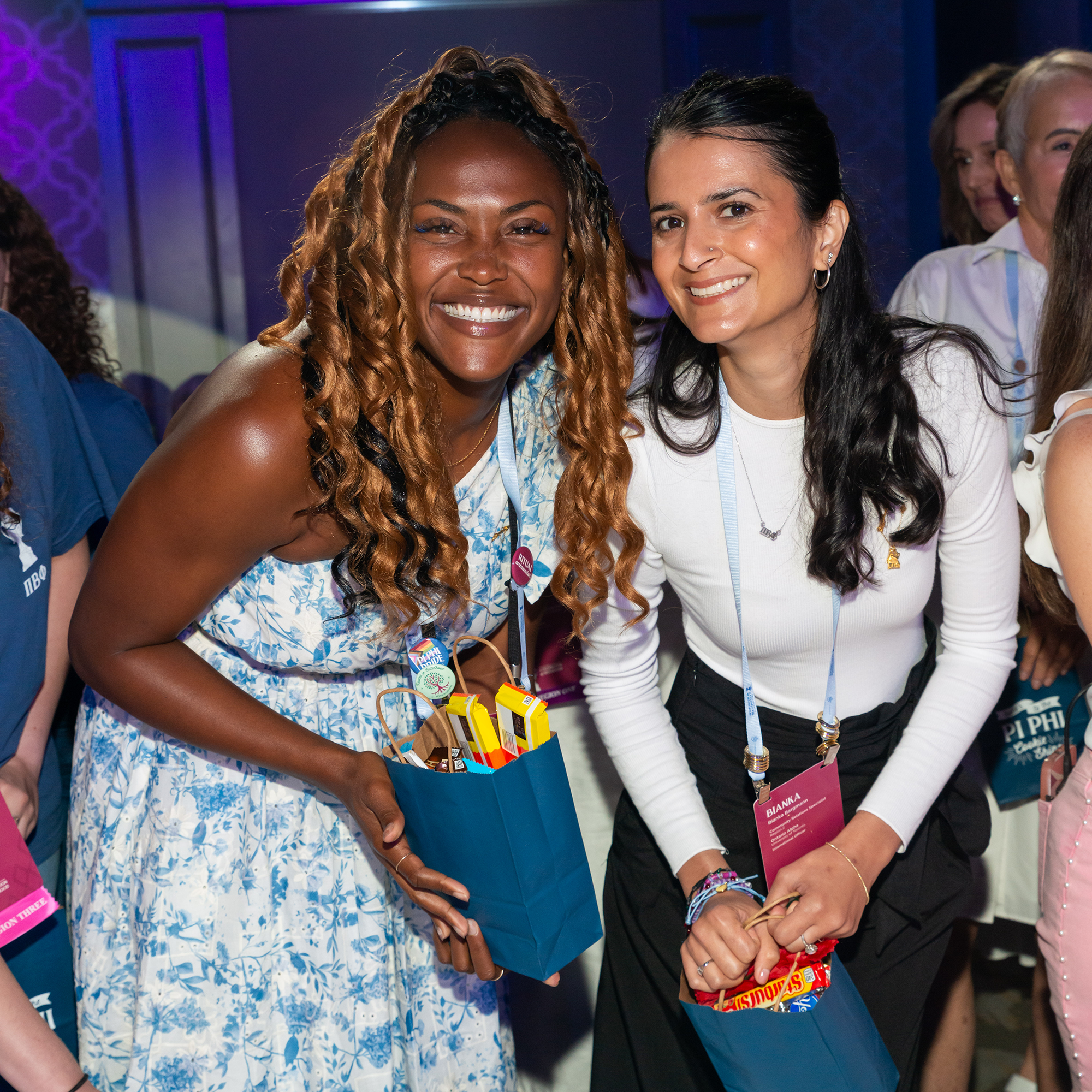 Two members holding bags filled with candy
