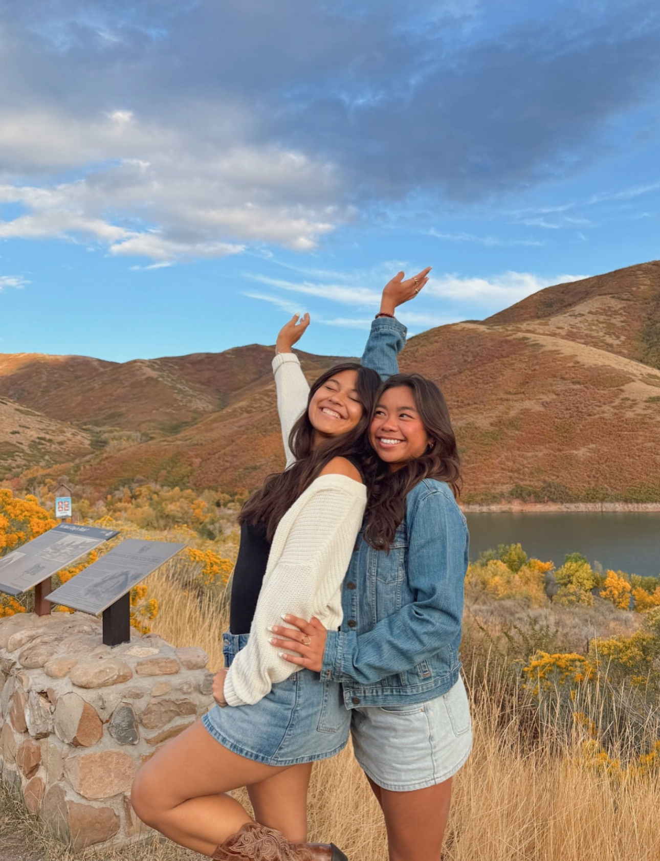 Two members standing in front of foothills