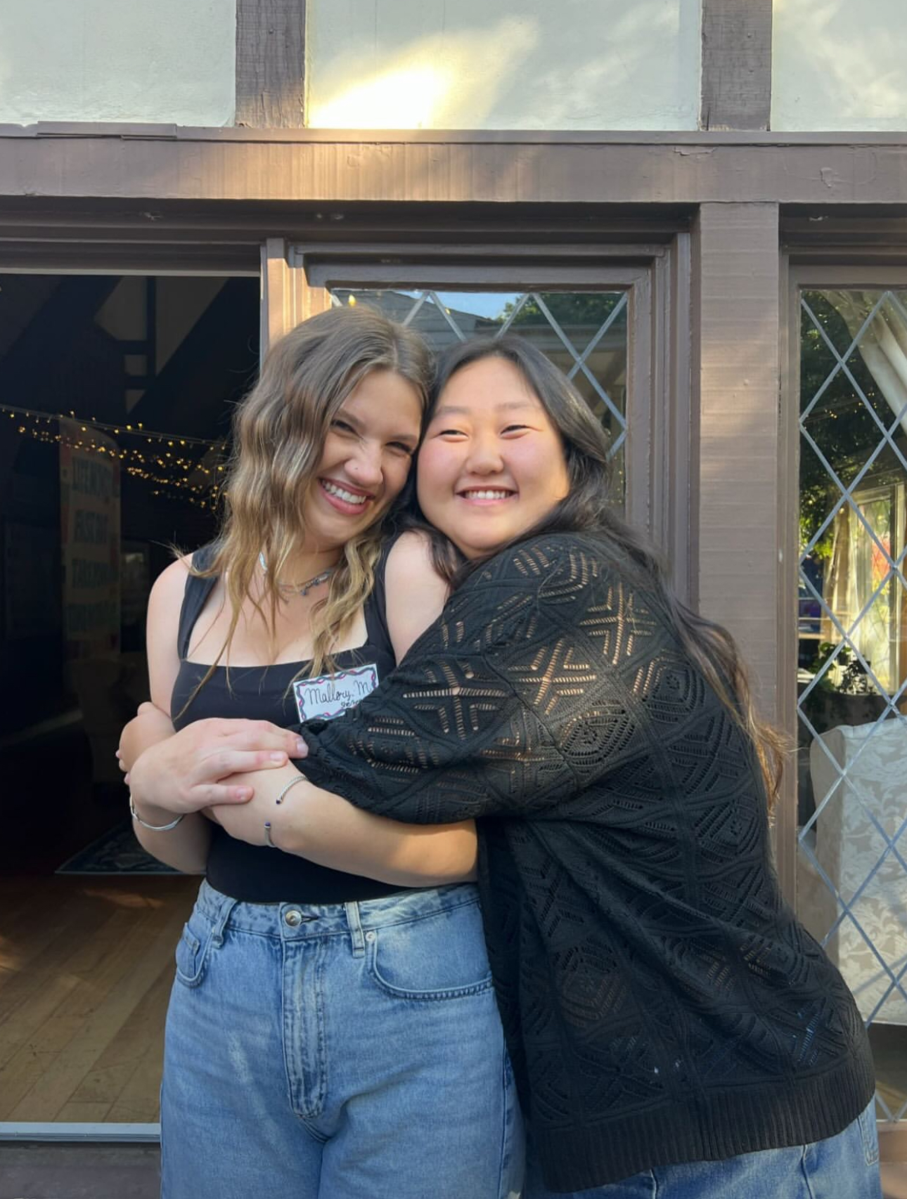 Two members hugging in front of the chapter
