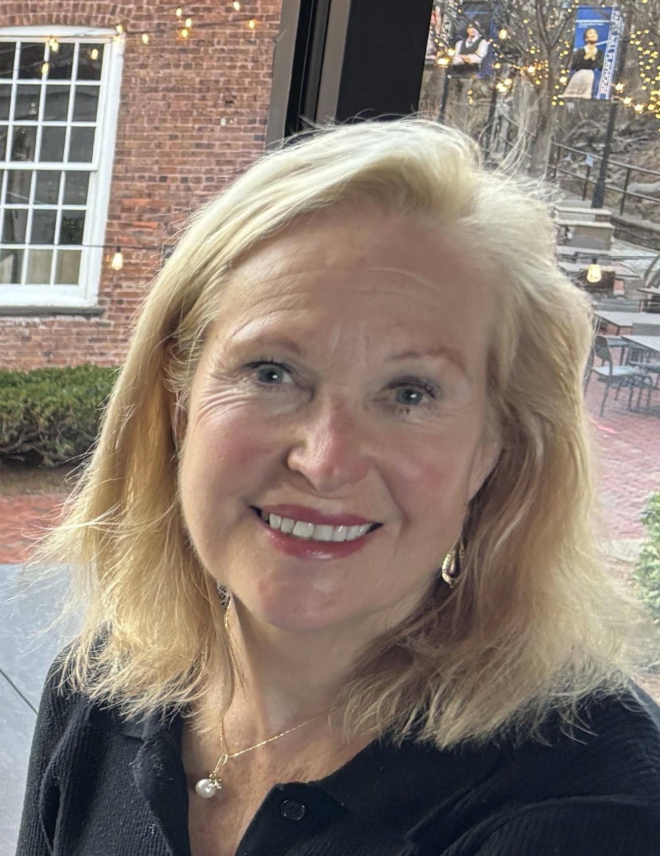 Professional headshot of Nancy Magee wearing a black blouse
